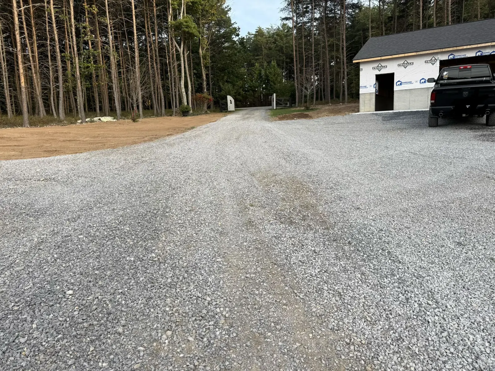 Fresh stone spread on a gravel drive and the apron at a garage