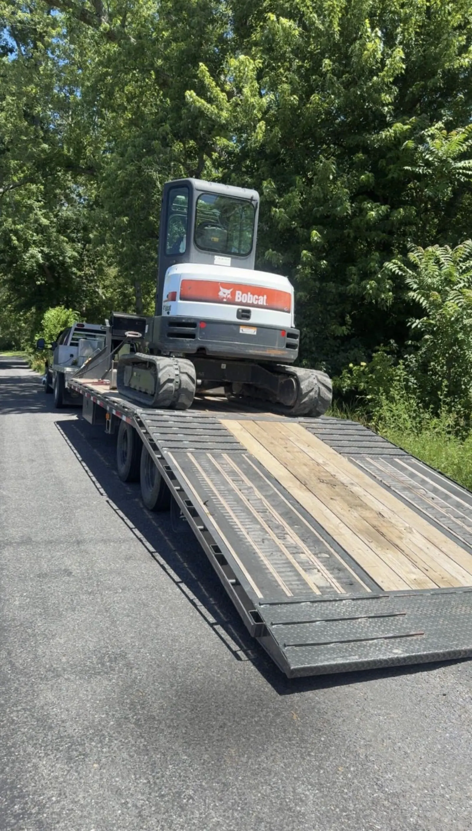 Mini excavator chained down on an equipment trailer