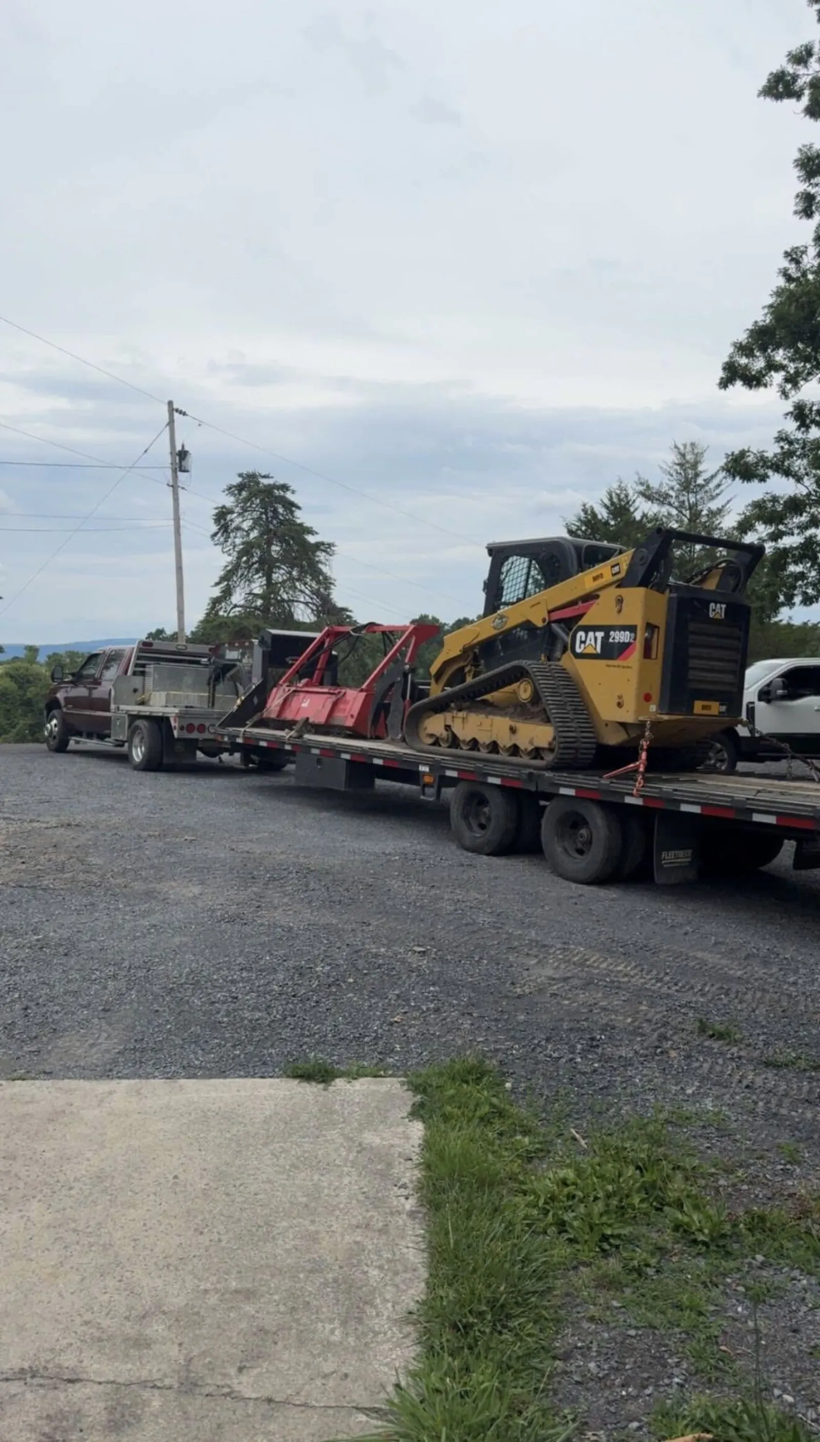 Pickup truck and trailer loaded with the compact track loader